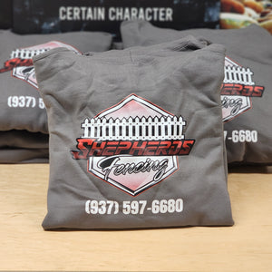 Stack of gray hoodies with company logo on the back