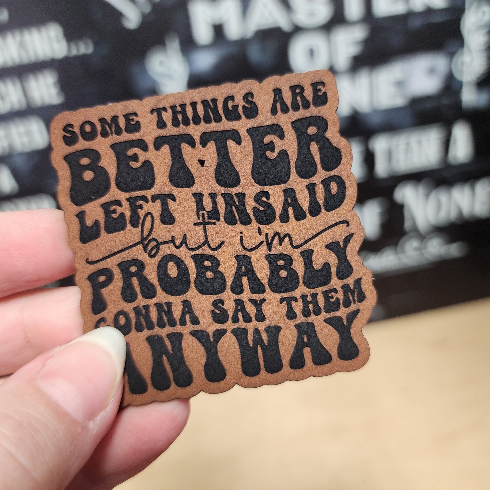 Inspirational leatherette hat patch with the quote: 'Some things are better left unsaid, but I'm probably gonna say them anyway.'