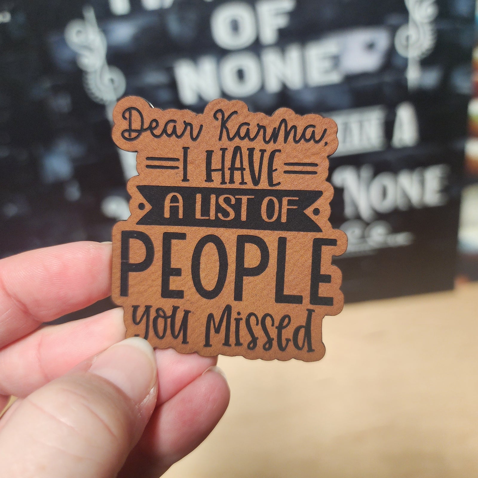 Humorous leatherette hat patch that says 'Dear Karma, I have a list of people you missed,' perfect for quirky gifts.