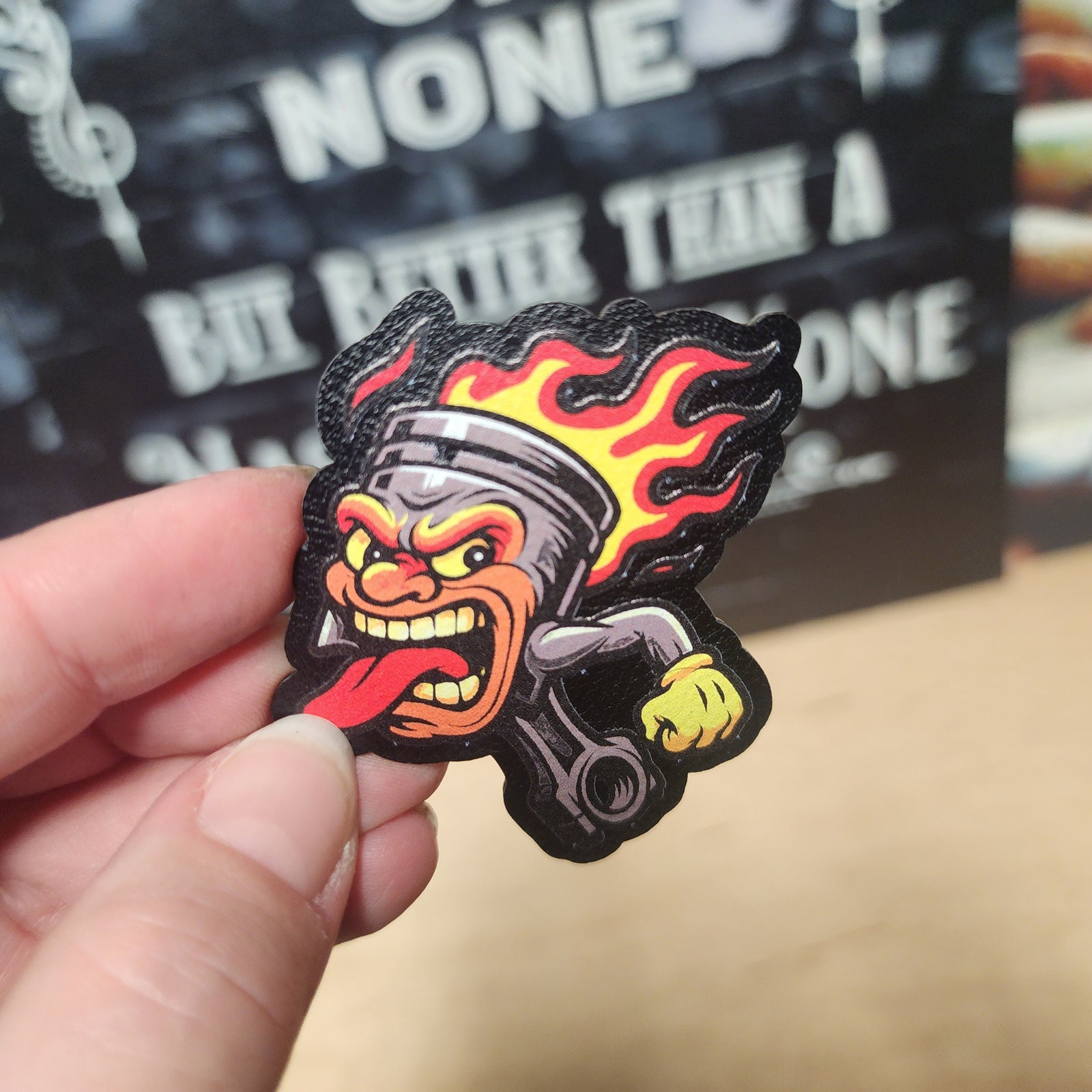 Fiery piston cartoon leatherette hat patch for car enthusiasts and hot rod lovers. Bold automotive accessory.