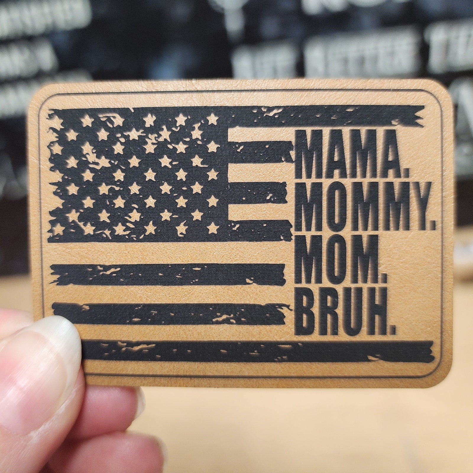 American flag leatherette hat patch with 'Mama. Mommy. Mom. Bruh.' message, perfect for stylish hat accessories.