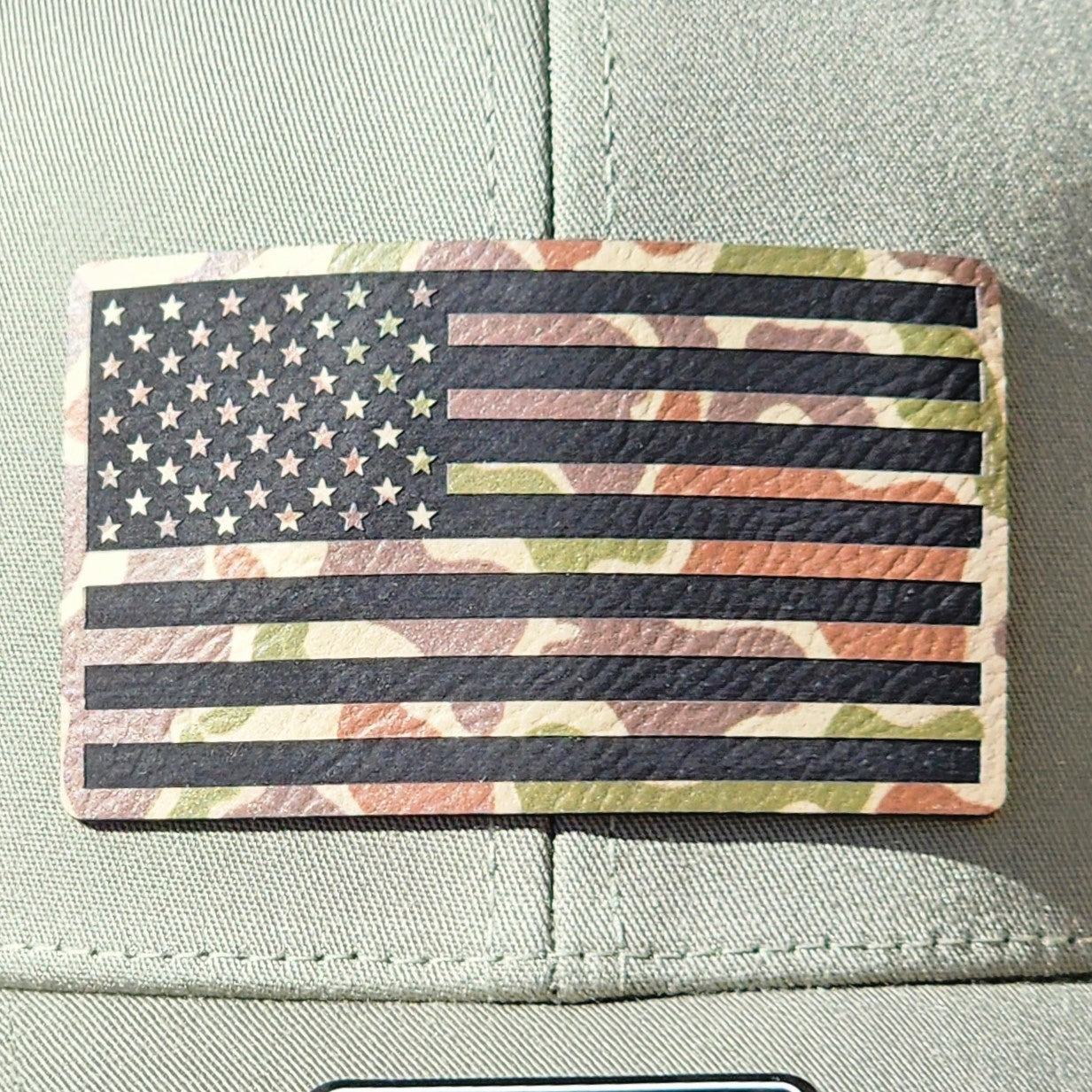 Camo American flag leatherette hat patch for outdoor enthusiasts and patriotic style hats.