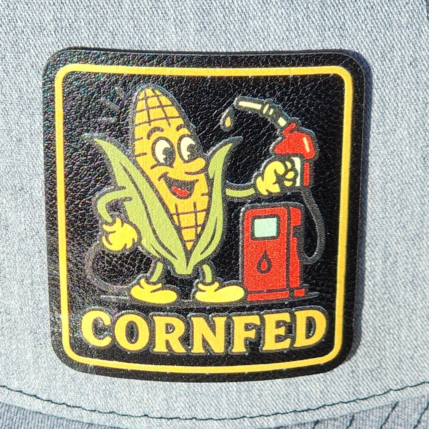 Cornfed leatherette hat patch with a cheerful corn character and a gas pump design for fun fashion accessories.