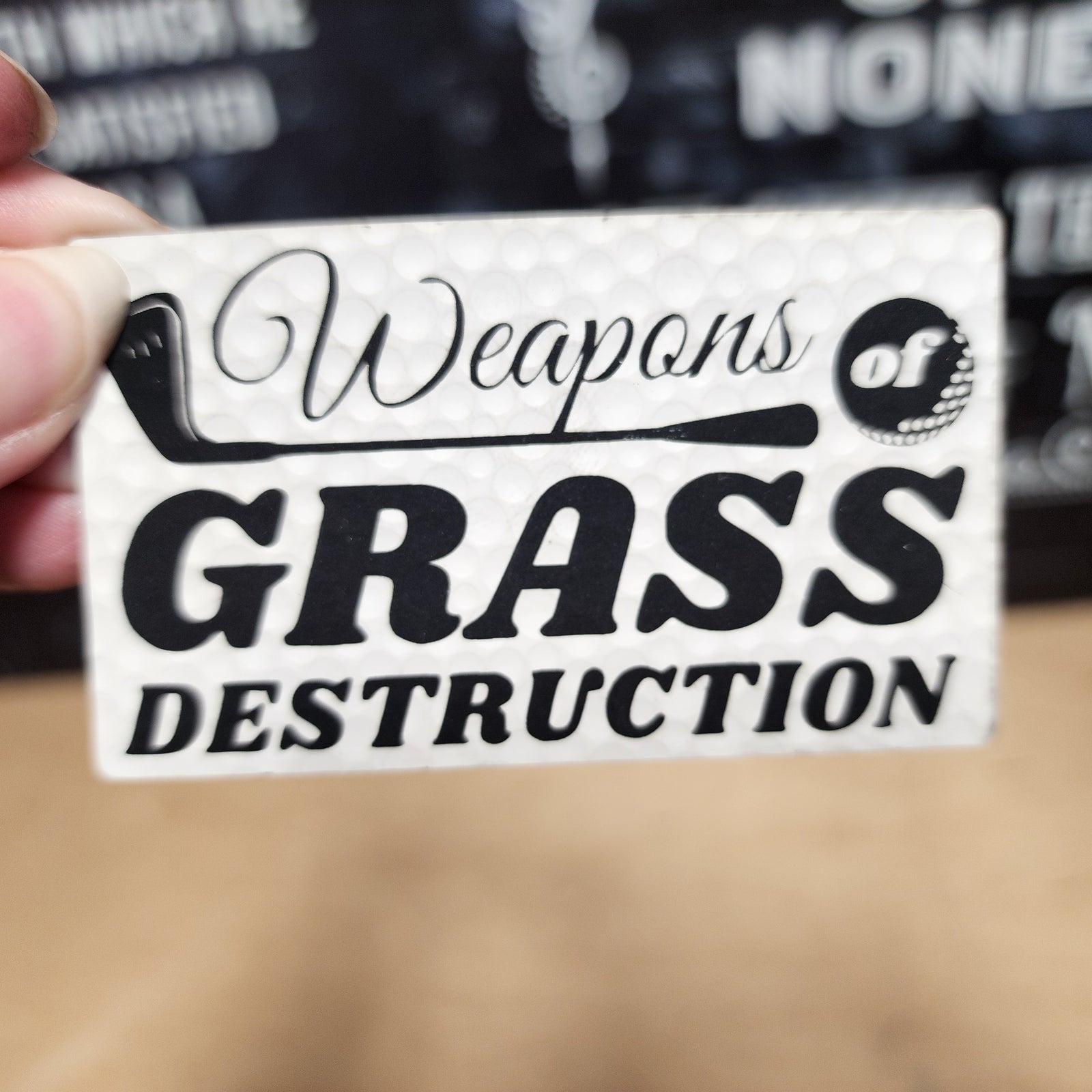 Weapons of Grass Destruction leatherette hat patch for golf lovers and lawn enthusiasts.