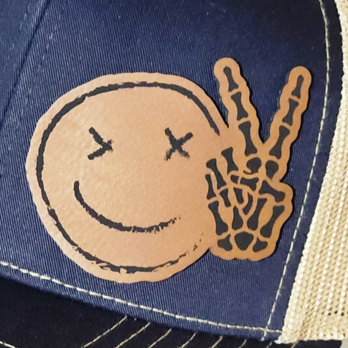Peace sign leatherette hat patch with smiley face, perfect for casual headwear and vintage style enthusiasts.