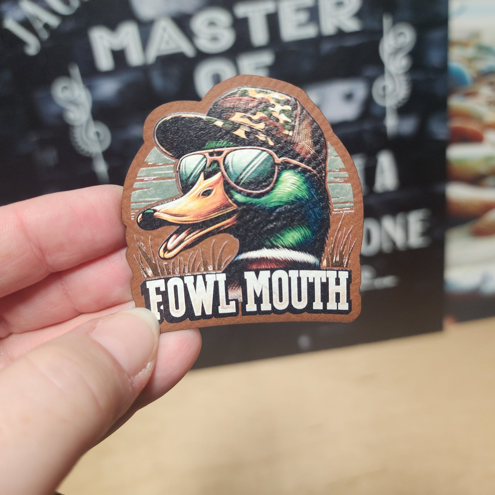 Fowl Mouth duck leatherette hat patch with sunglasses, perfect for outdoor enthusiasts and casual wear.