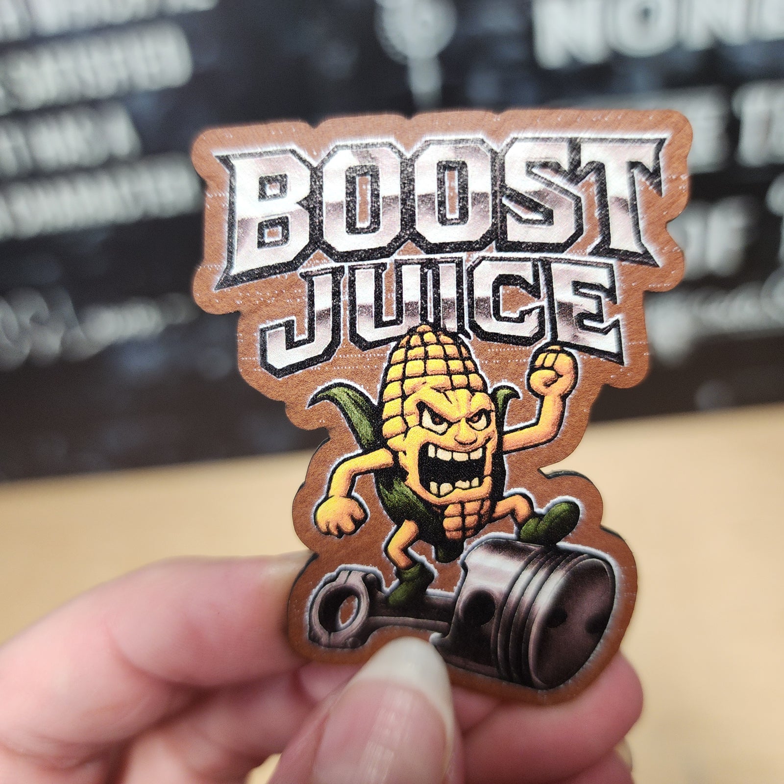 Boost Juice corn character leatherette hat patch, perfect for automotive enthusiasts and quirky fashion.