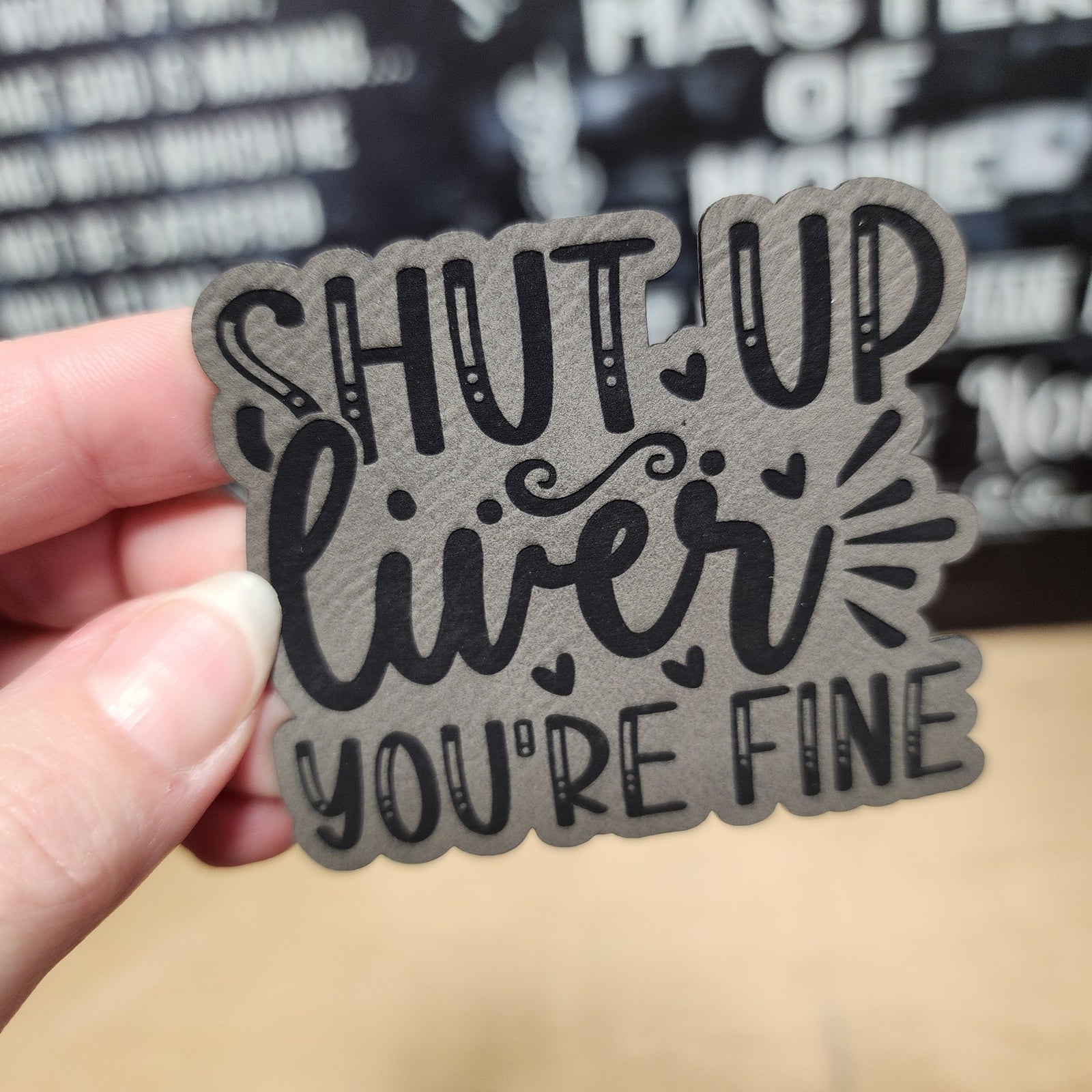 Funny leatherette hat patch with the phrase 'Shut Up Liver You're Fine' for party or drink lovers.