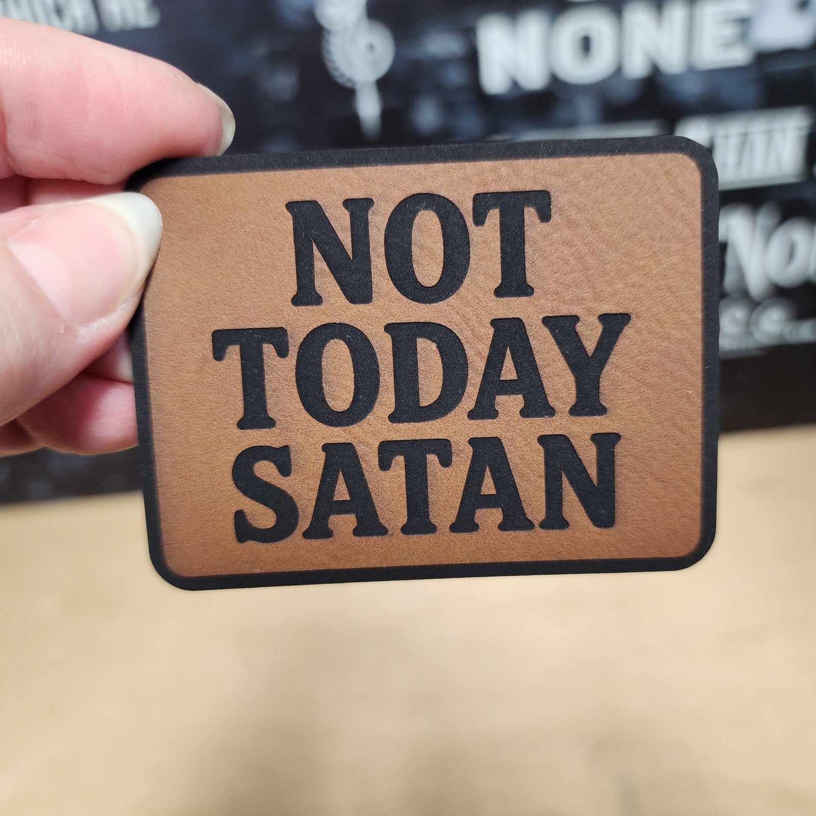 Funny leatherette patch with 'Not Today Satan' quote, perfect for hats and daily humor accessories.