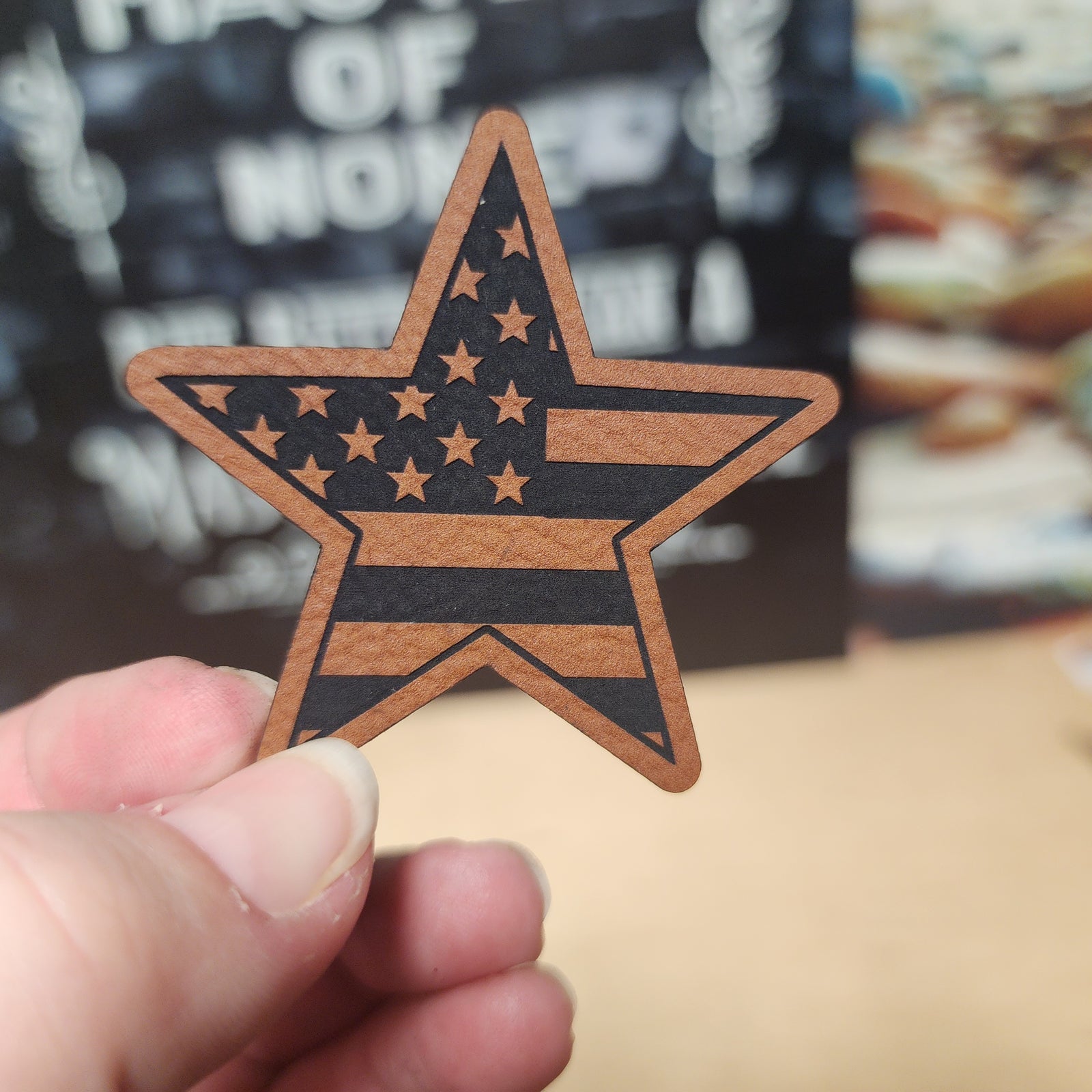 Star-shaped leatherette hat patch with American flag design, perfect for patriotic apparel and accessories.