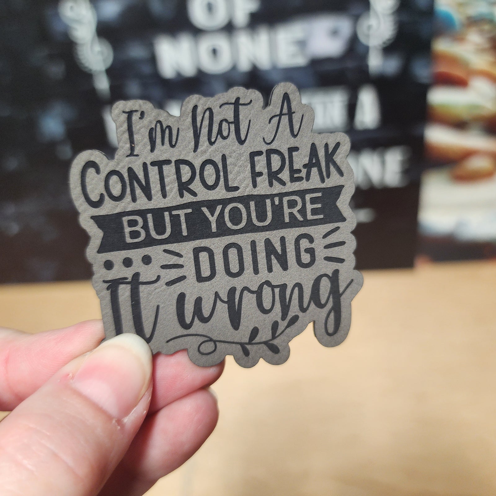 Control Freak leatherette hat patch with humorous quote for quirky accessories enthusiasts.