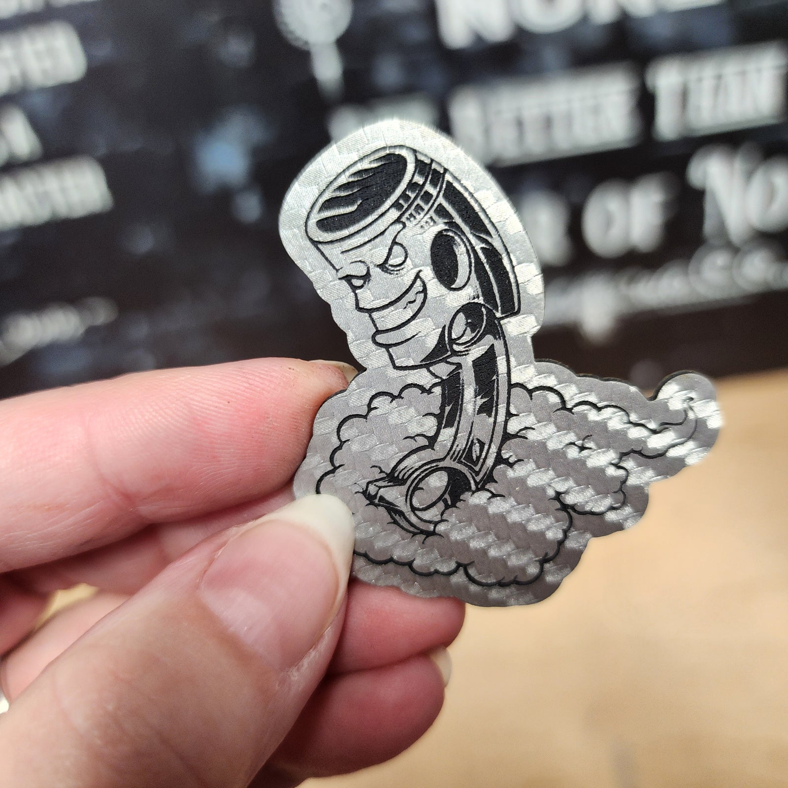 Custom leatherette hat patch featuring a cartoon piston with smoke, perfect for automotive enthusiasts.