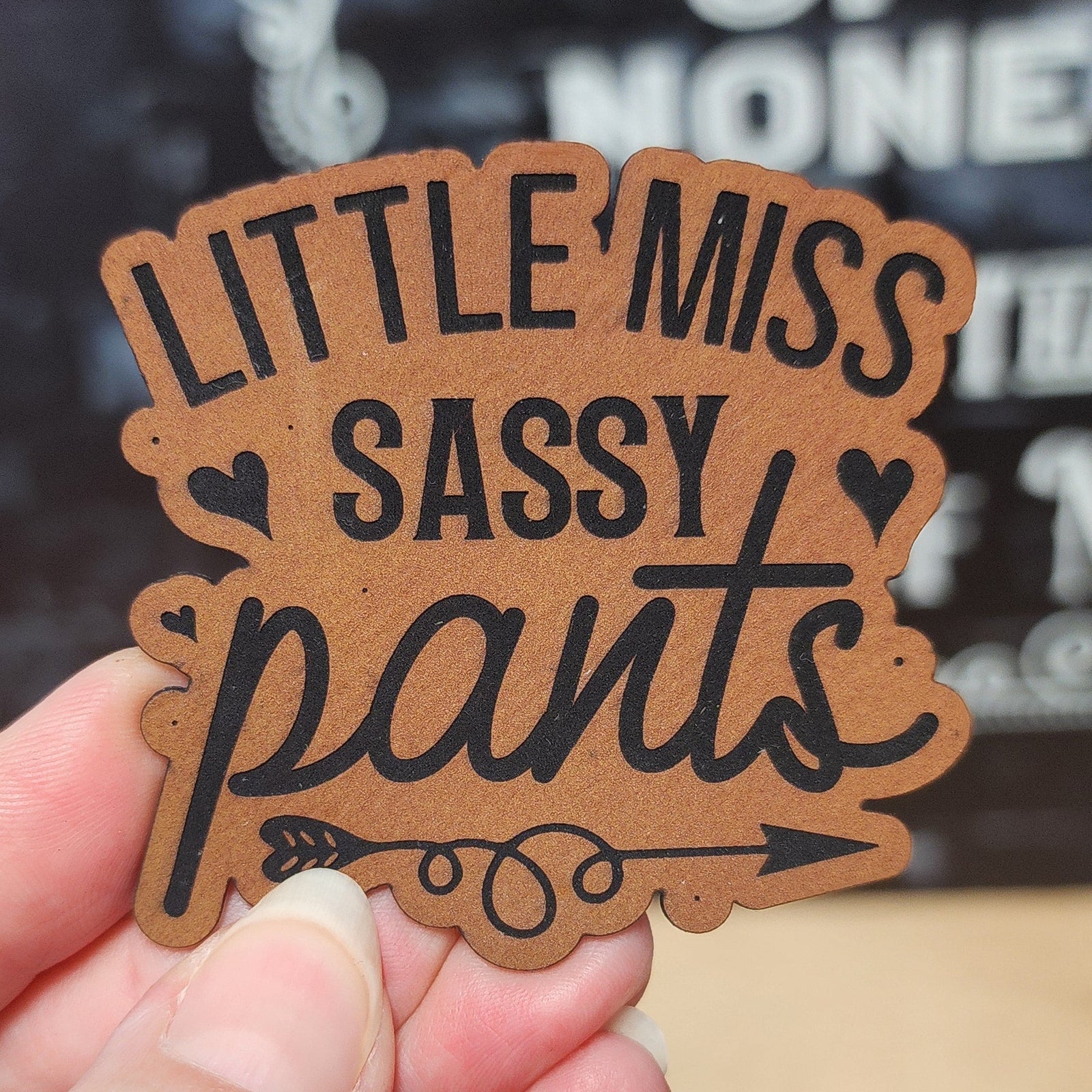 Little Miss Sassy Pants leatherette hat patch, perfect for adding a fun touch to your favorite caps and accessories.