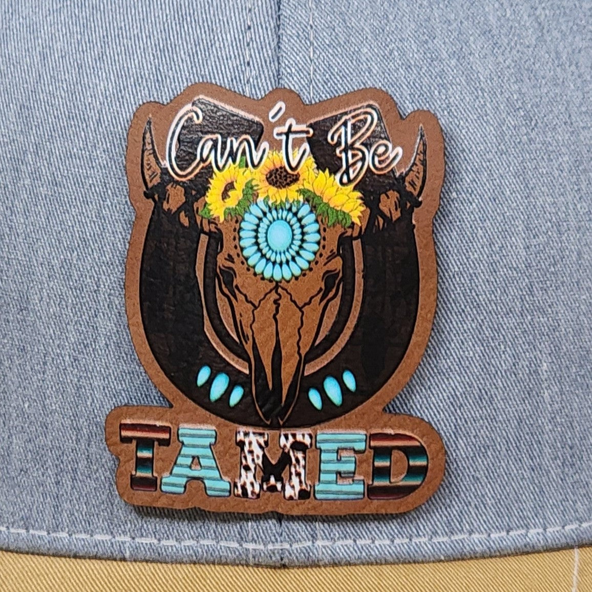 Cow skull leatherette hat patch with vibrant flowers and turquoise accents, perfect for rustic western style. 