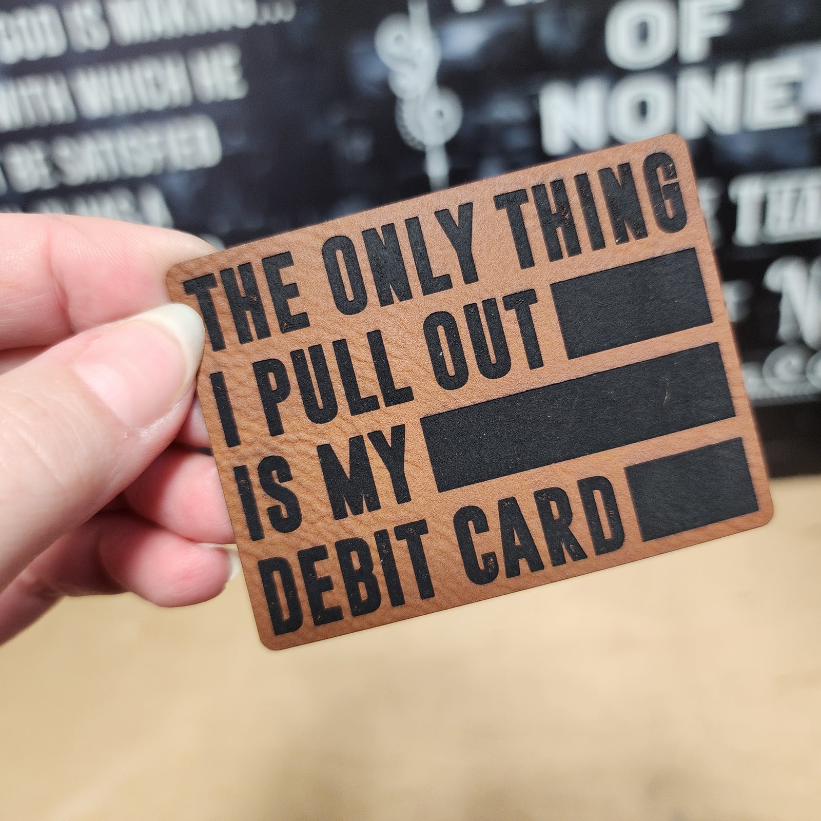 Funny leatherette hat patch, perfect for expressive style, featuring a humorous debit card quote for hats.