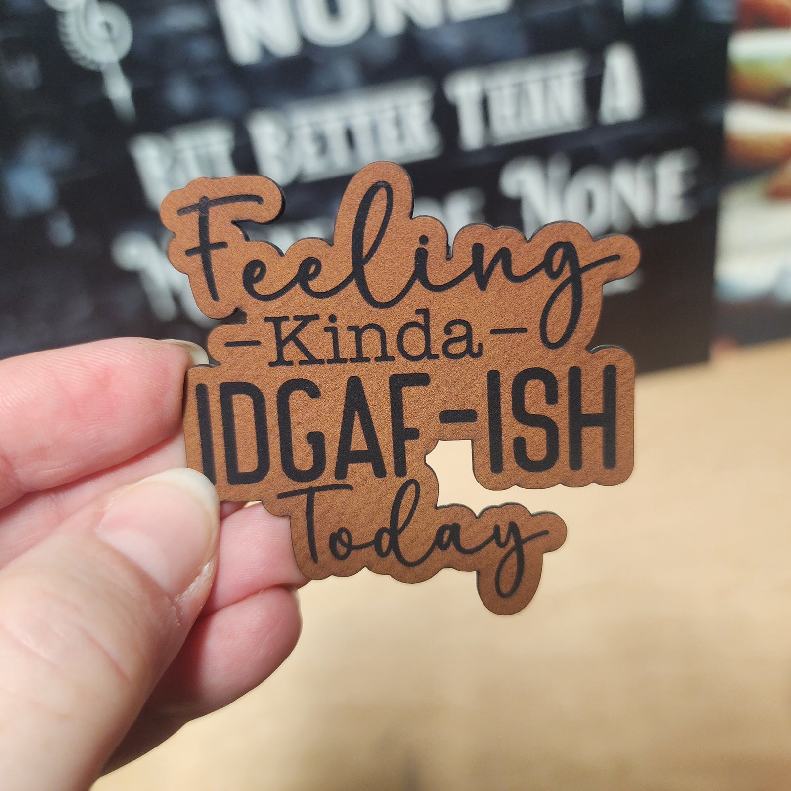 Leatherette hat patch that says 'Feeling Kinda IDGAF-ISH Today', perfect for casual and expressive accessories.
