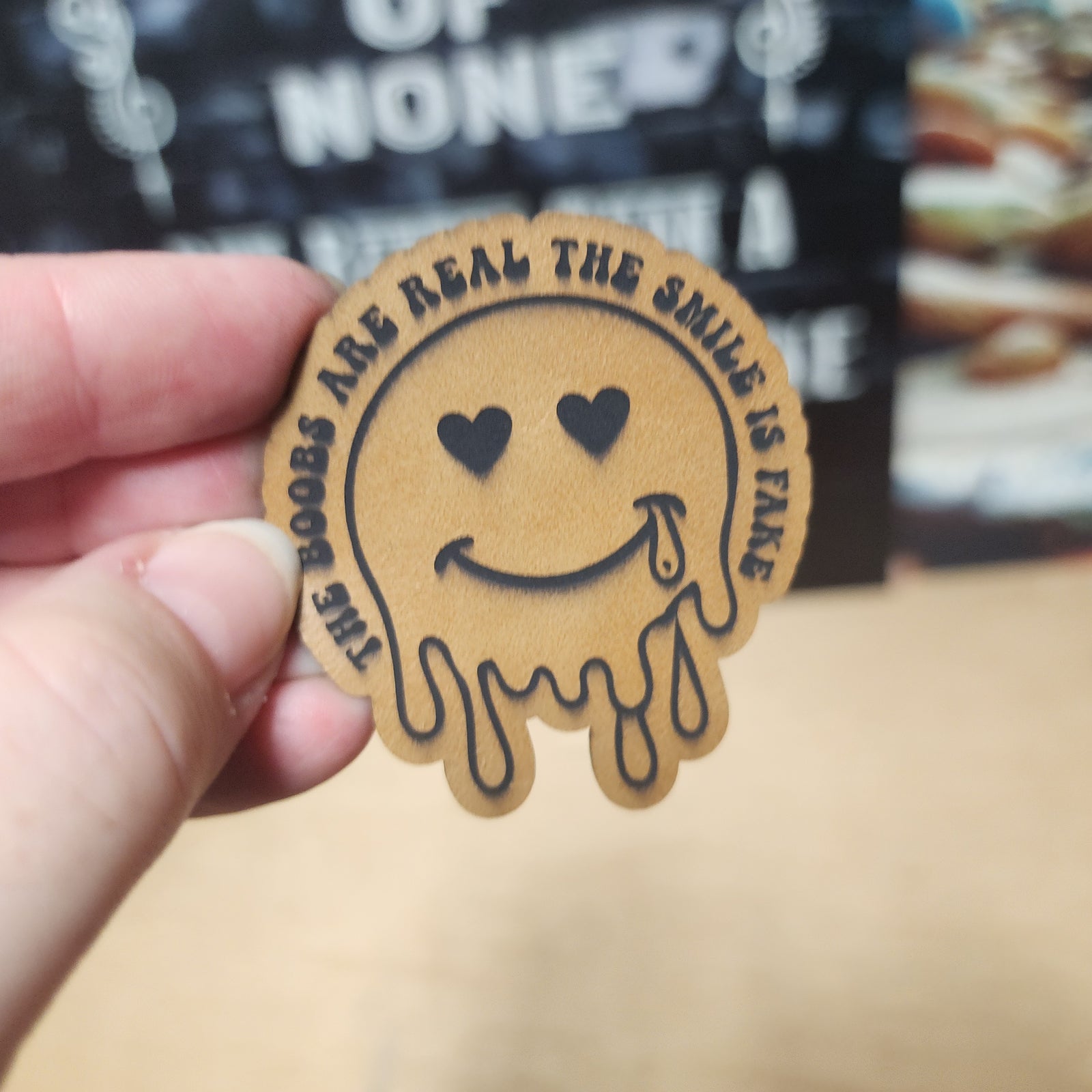Funny leatherette hat patch featuring a dripping smiley face with cheeky text for casual wear lovers.