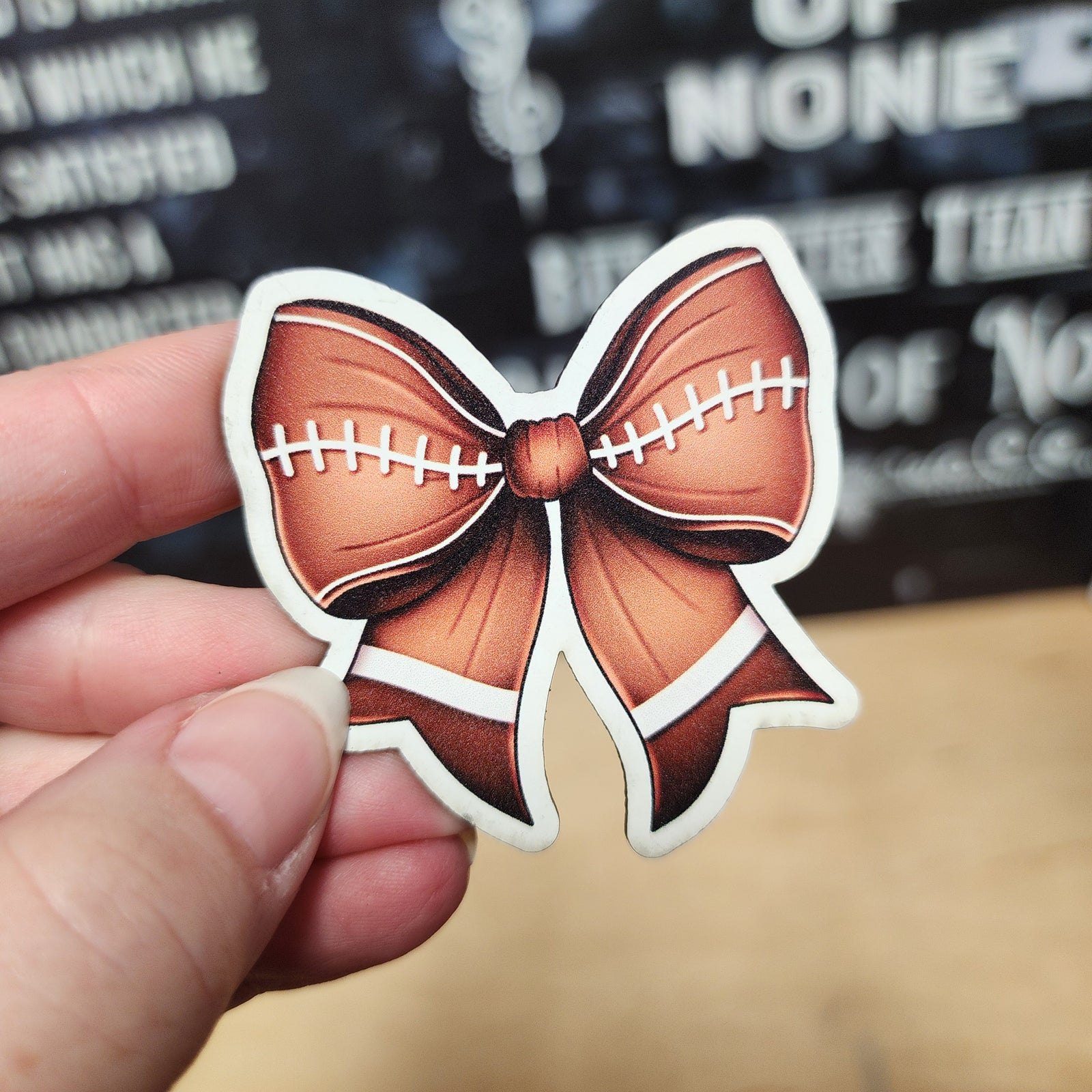 Football-themed leatherette hat patch with a stylish bow design, perfect for sports fans and fashion lovers.