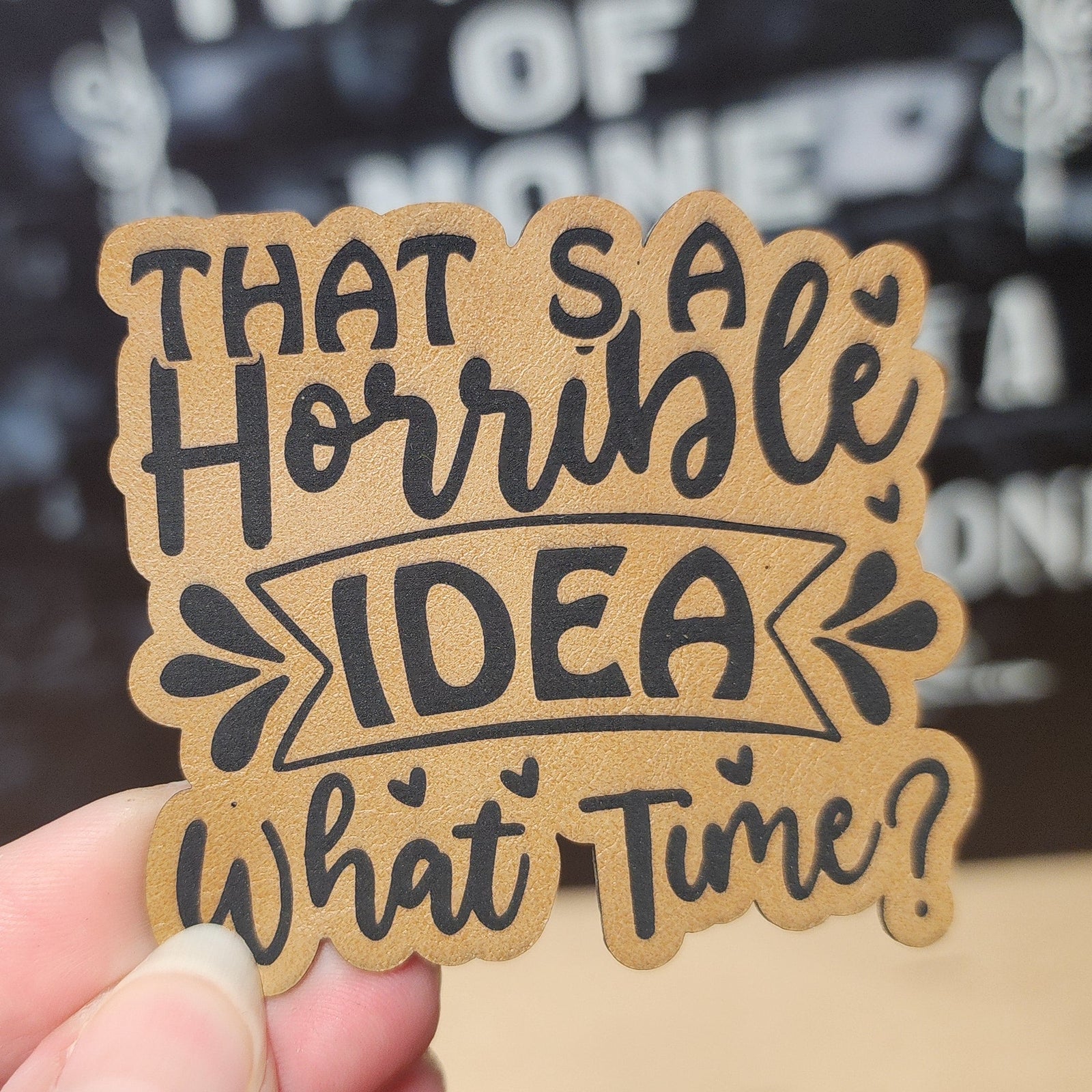 Funny leatherette hat patch with the phrase 'That’s a Horrible Idea, What Time?' for casual accessories.