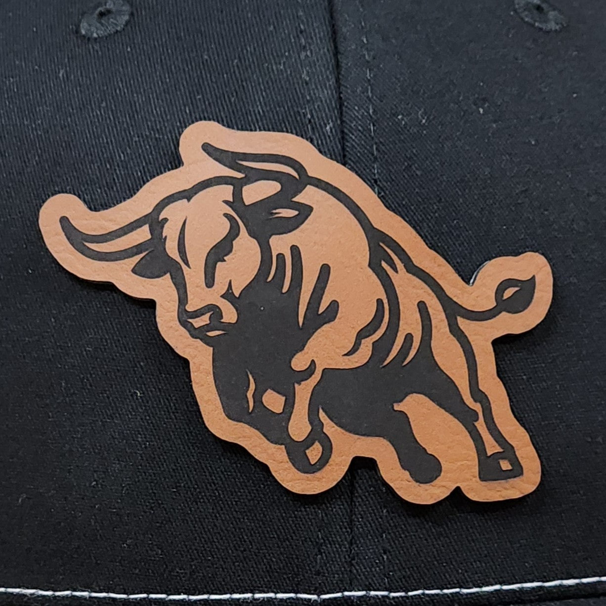 Leatherette bull hat patch for cowboy hats, western style headwear, great for rodeo enthusiasts and ranch wear.