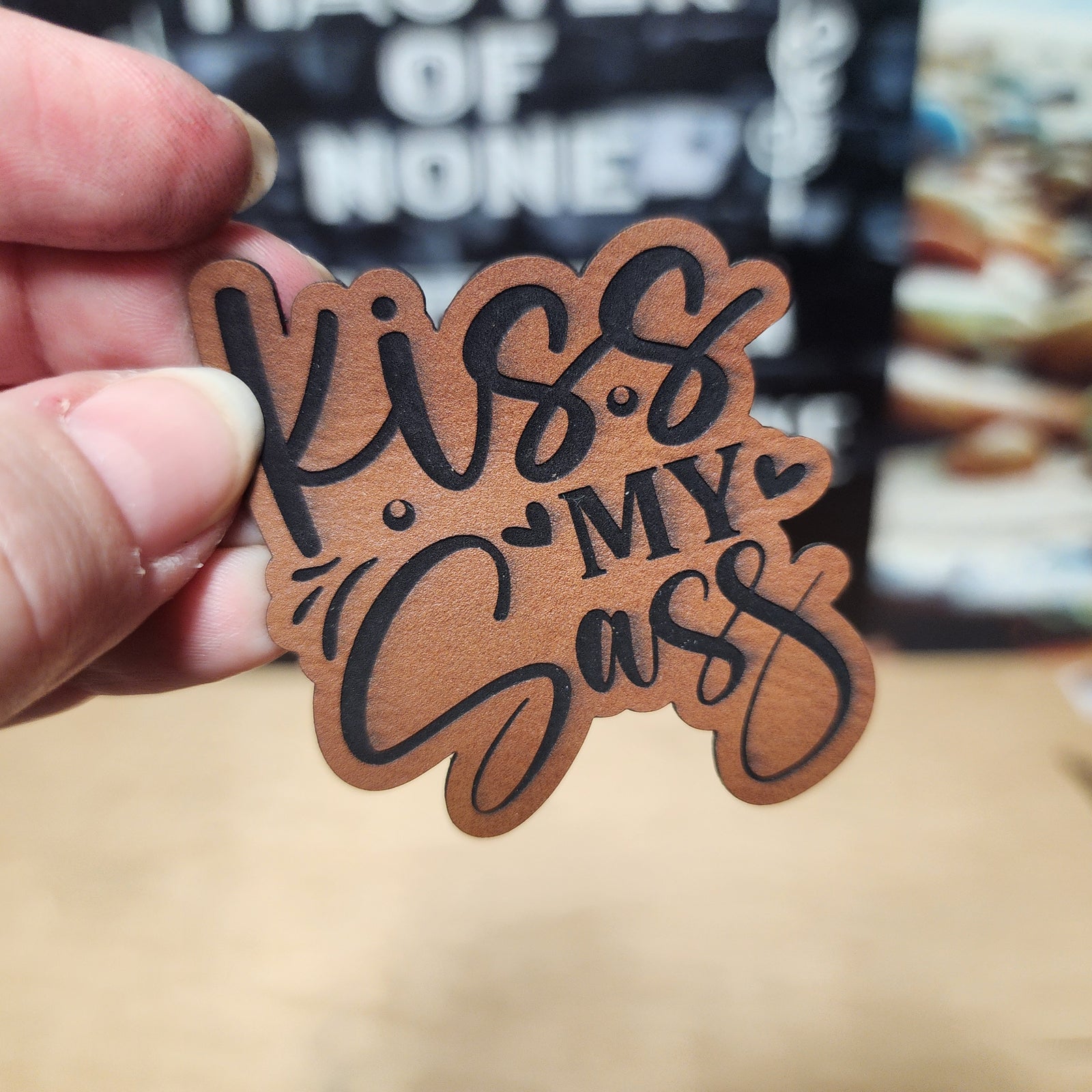 Kiss My Sass leatherette hat patch, perfect for adding attitude to your favorite hats or gear.