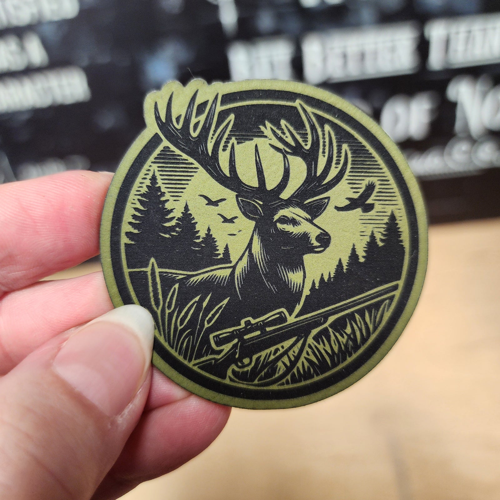Hunting themed leatherette hat patch featuring a majestic stag with rifle, perfect for outdoor enthusiasts.