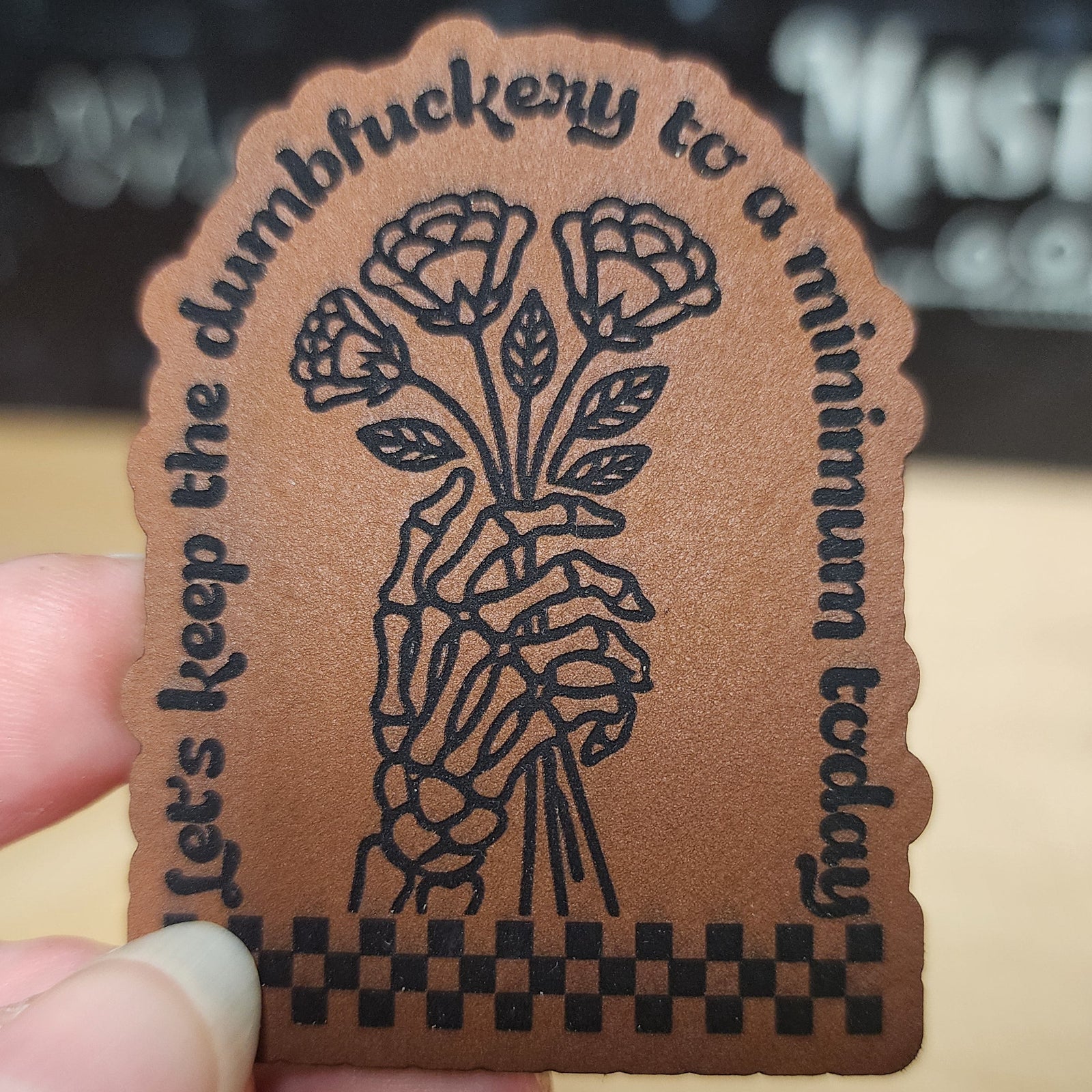Leatherette hat patch featuring floral design and quote 'Let's keep the dumbfuckery to a minimum today'.