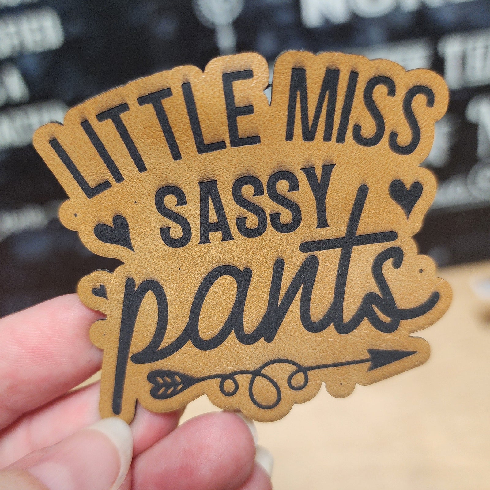 Little Miss Sassy Pants leatherette hat patch, perfect for adding a fun touch to caps and jackets.