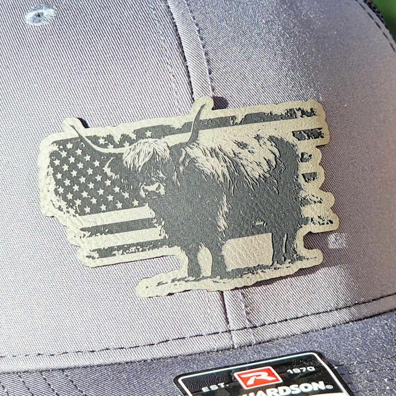 Highland cow leatherette hat patch with American flag design for rustic style caps and outdoor apparel.