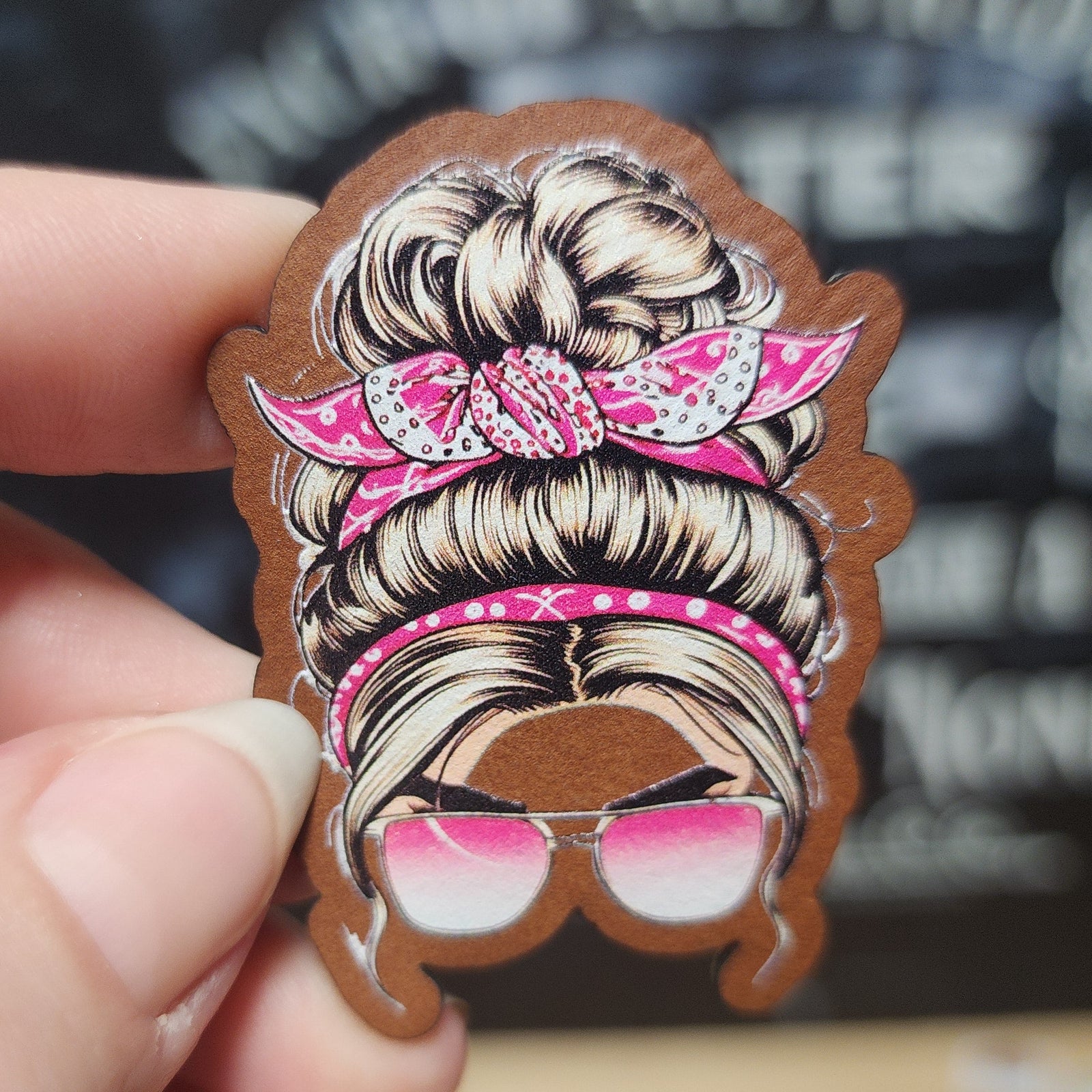 Trendy leatherette hat patch featuring stylish blonde bun with pink sunglasses, perfect for hats and accessories.