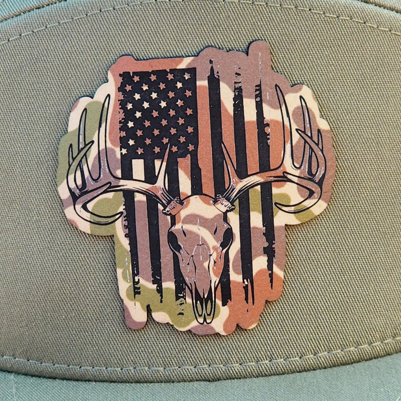 Hunting cap patch, deer skull with American flag camo design for patriotic outdoor enthusiasts.