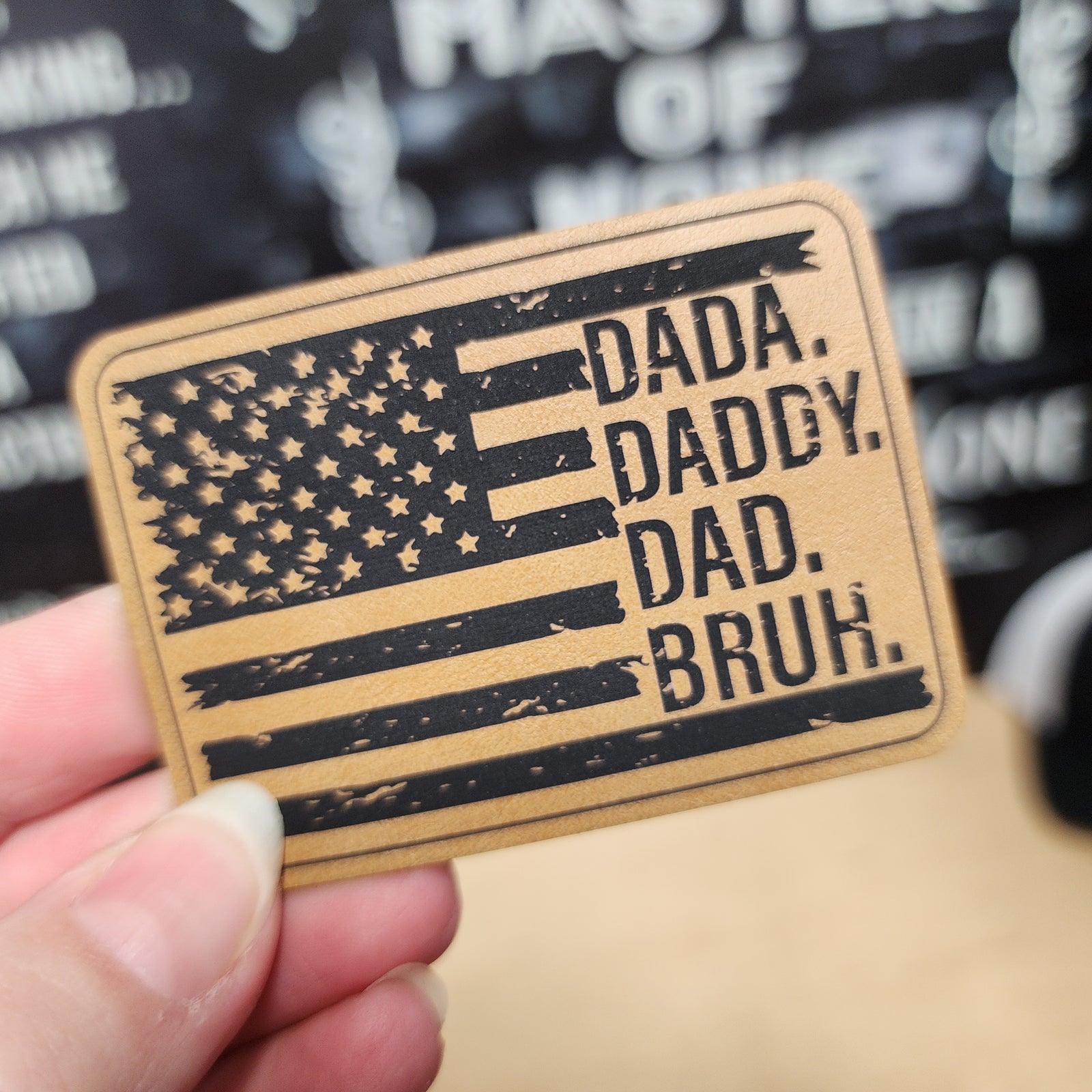 Leatherette dad patch with American flag design featuring words DADA, DADDY, DAD, BRUH for Father's Day gifts.