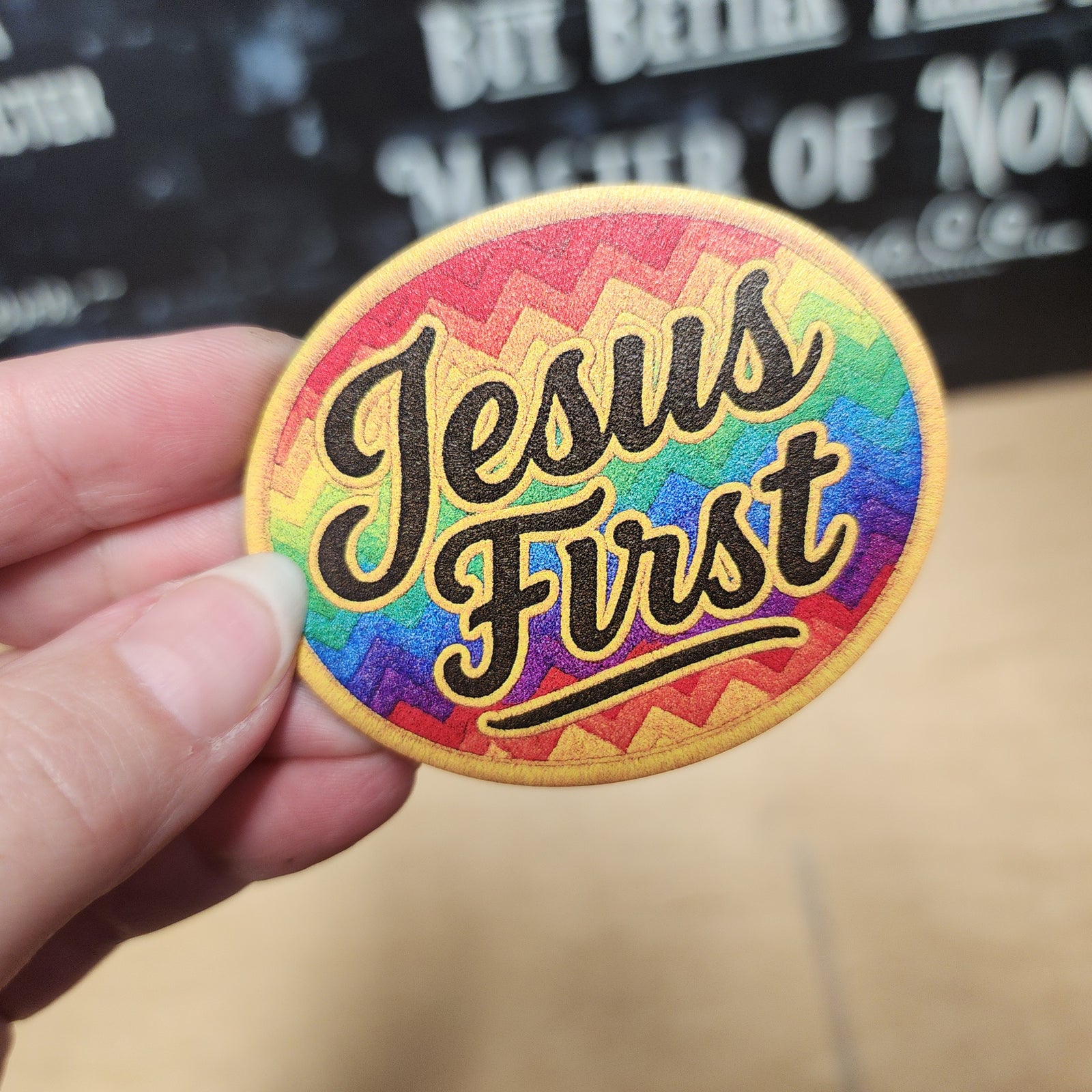 Colorful Jesus First leatherette hat patch with a vibrant rainbow zigzag design, perfect for Christian-themed apparel.