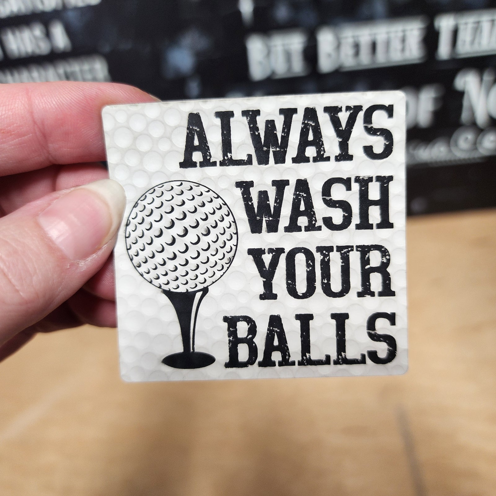 Funny golf leatherette patch with slogan 'Always Wash Your Balls' for golf enthusiasts and gift ideas.