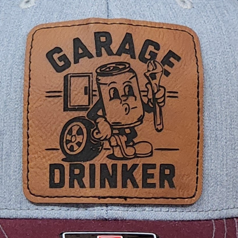 Garage Drinker leatherette hat patch featuring a cartoon can character with a wrench for car enthusiasts.