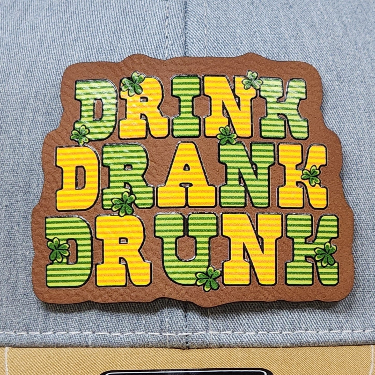 St. Patrick's Day leatherette hat patch featuring funny Drink Drank Drunk design with shamrocks.