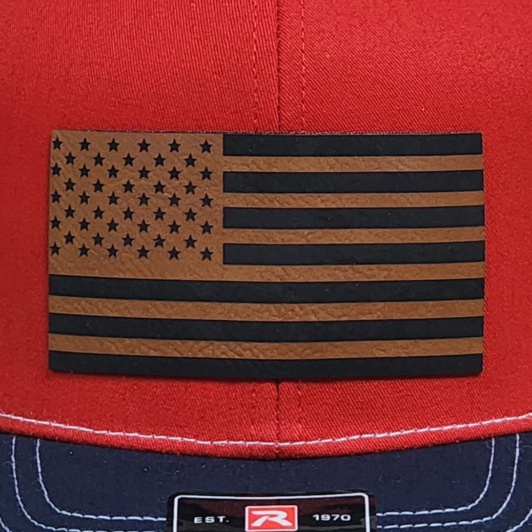 Leatherette American flag hat patch on red cap, perfect for patriotic lovers and outdoor enthusiasts.