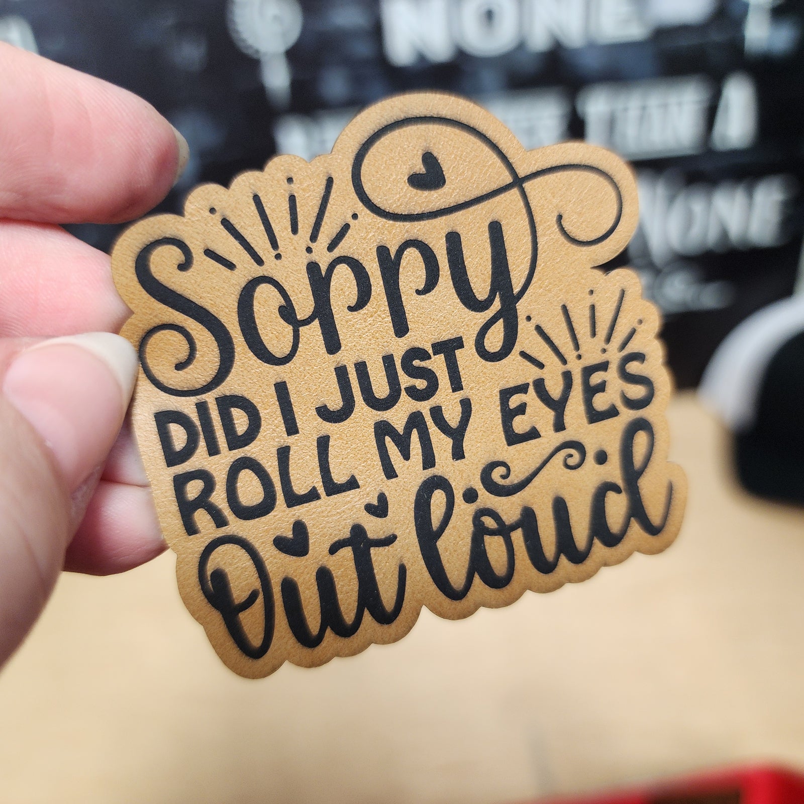 Humorous leatherette hat patch with text: 'Sorry did I just roll my eyes out loud' for quirky fashion accessories.