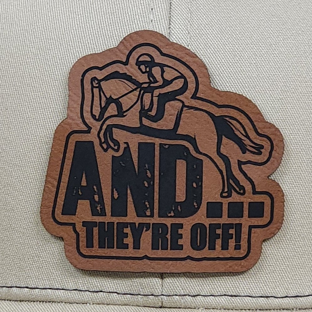 Horse racing leatherette hat patch featuring rider with text 'AND... THEY'RE OFF!' for equestrian enthusiasts.