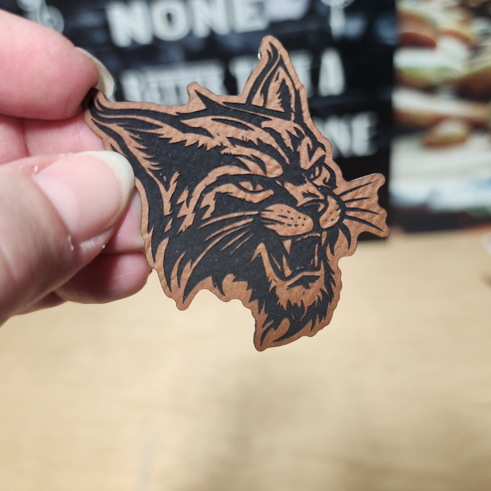 Leatherette wildcat hat patch, fierce animal design for unique outdoor apparel or stylish cap accessories.