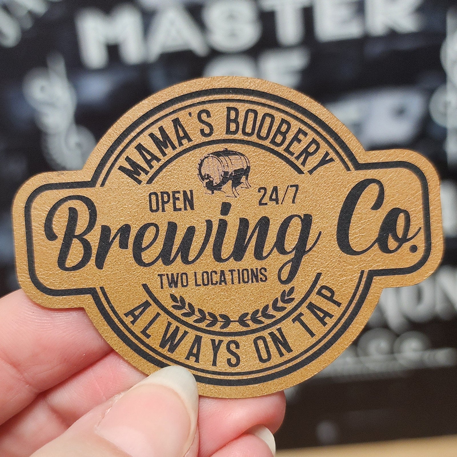 Mama's Boobery Brewing Co leatherette hat patch for craft beer enthusiasts, perfect for brewery merchandise collection.