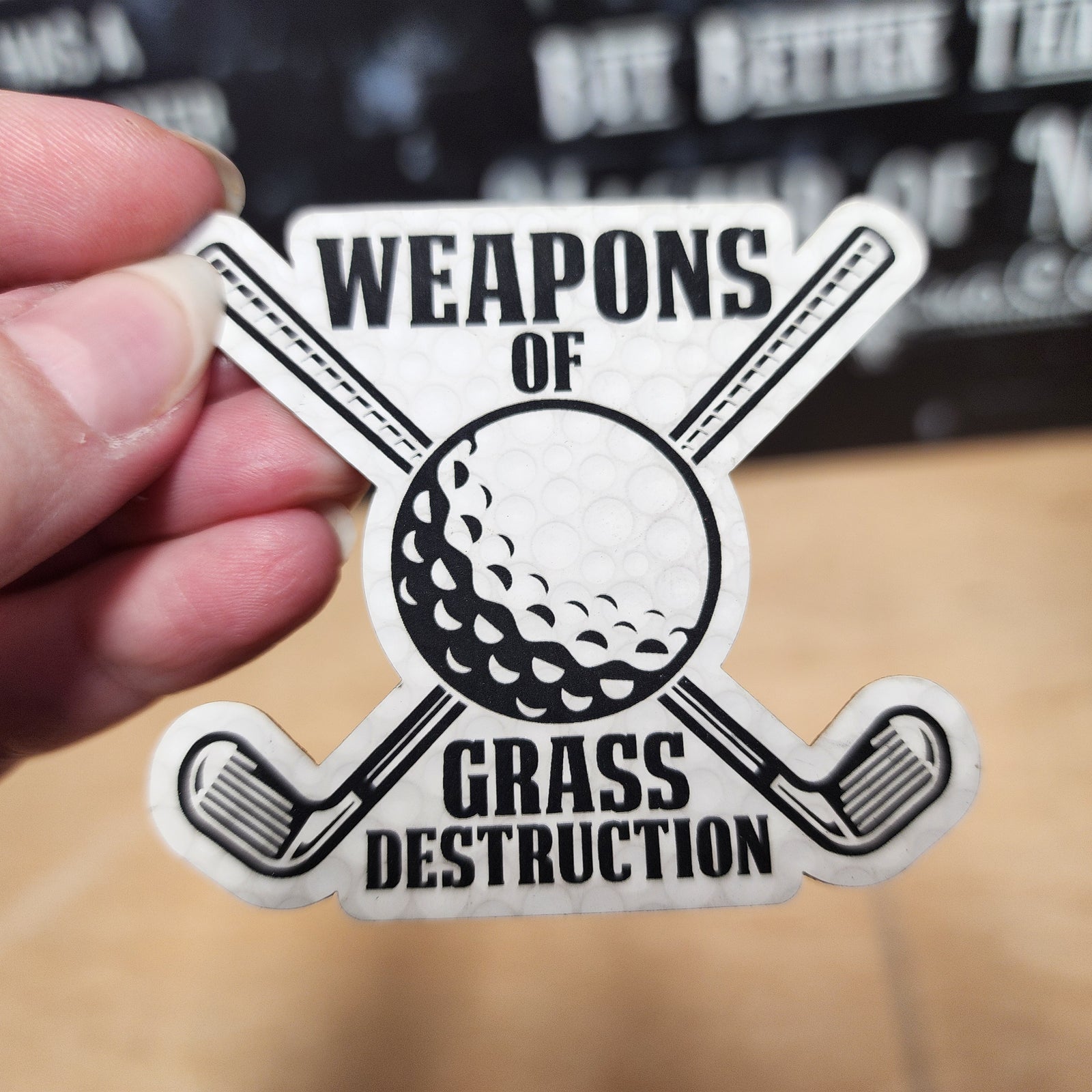 Weapons of Grass Destruction leatherette hat patch featuring crossed golf clubs and a golf ball for sports enthusiasts.