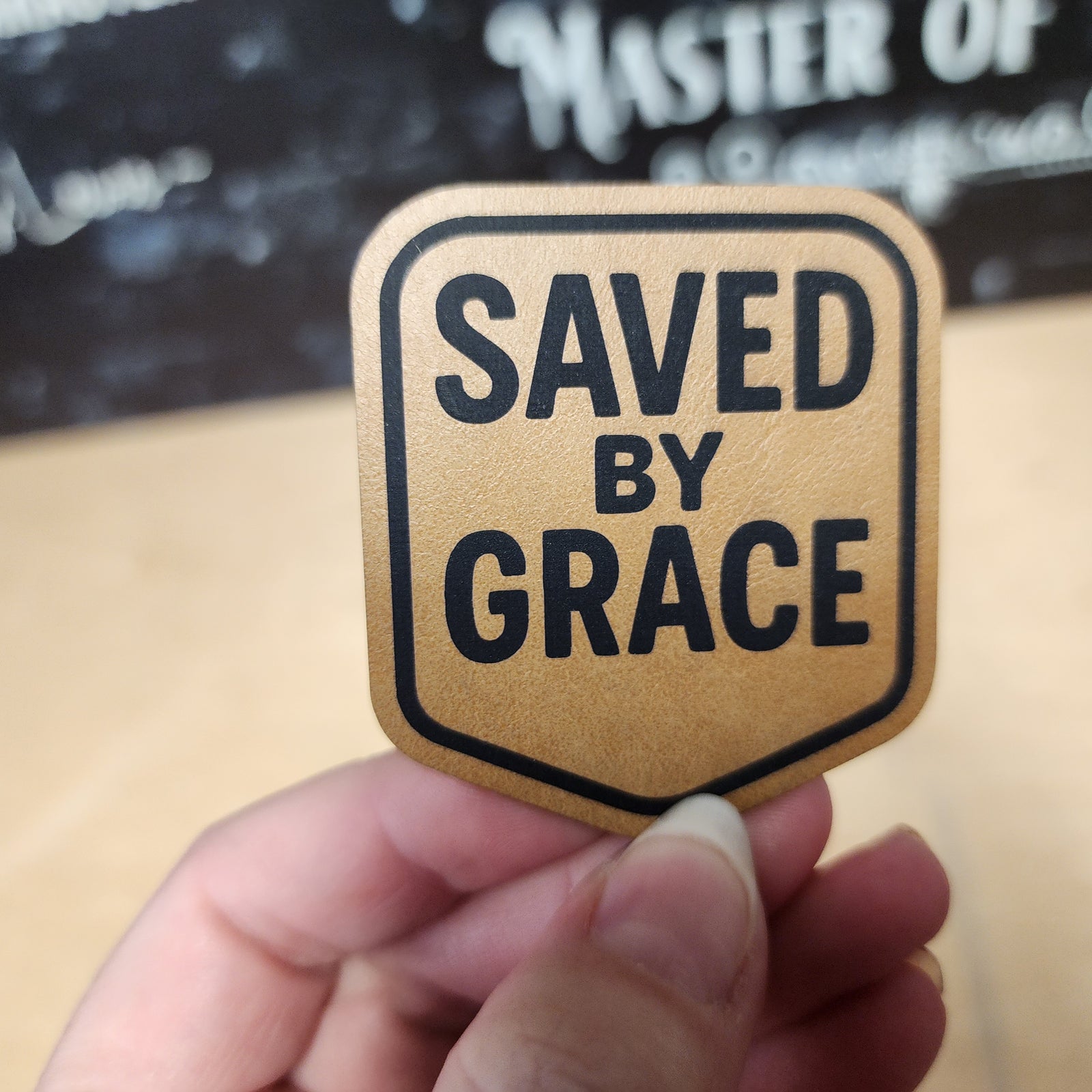 Saved by Grace leatherette hat patch for faith-inspired fashion accessories, perfect for hats and bags.
