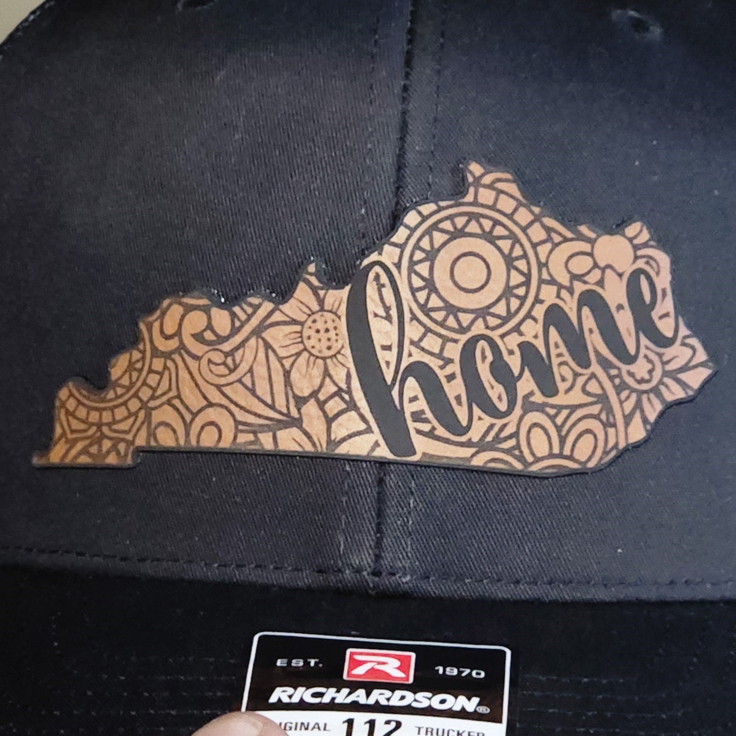 Kentucky home leatherette hat patch with unique floral design, perfect for showcasing state pride. Trendy trucker cap accessory.