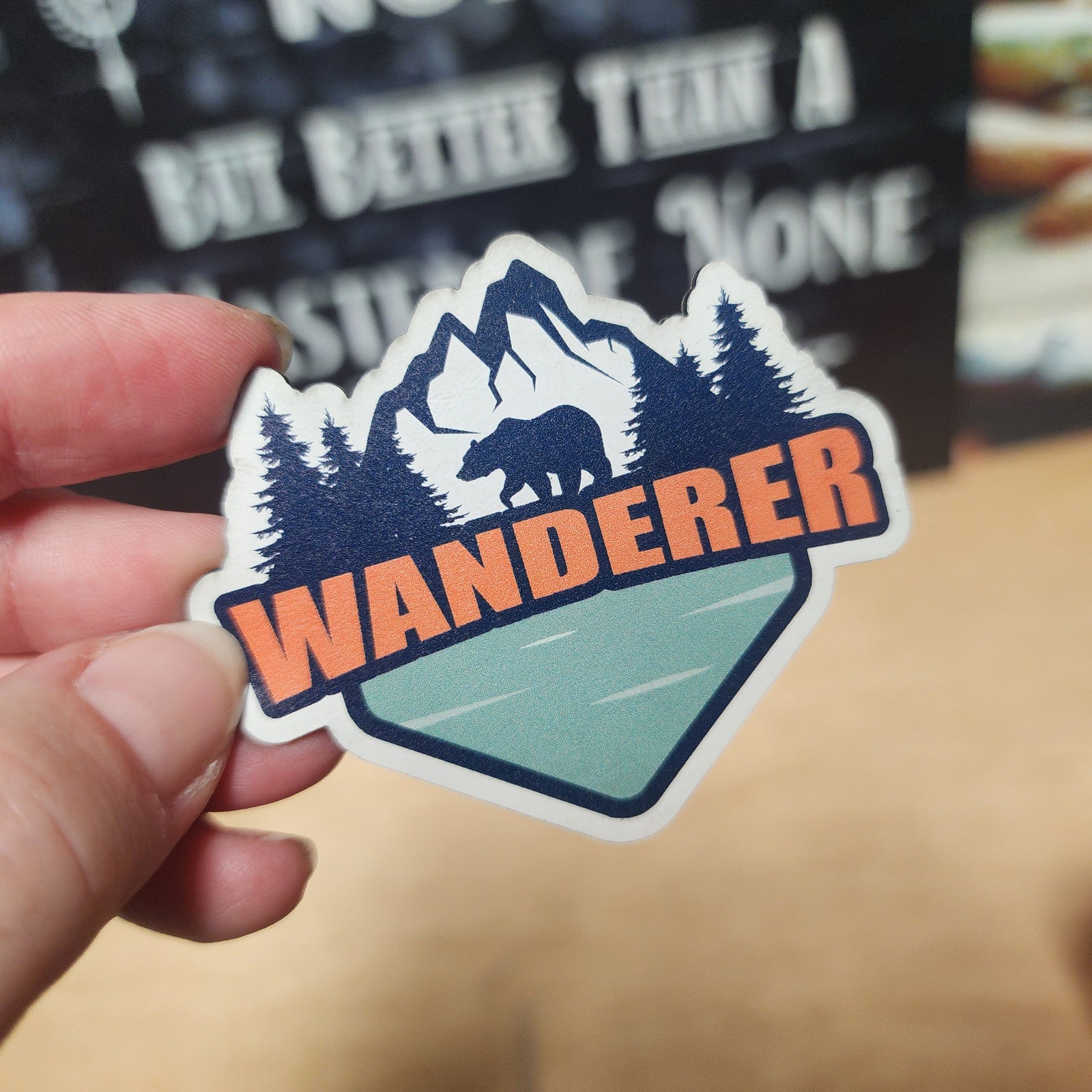 Wanderer outdoor leatherette hat patch featuring mountains, trees, and a bear, perfect for adventure lovers.