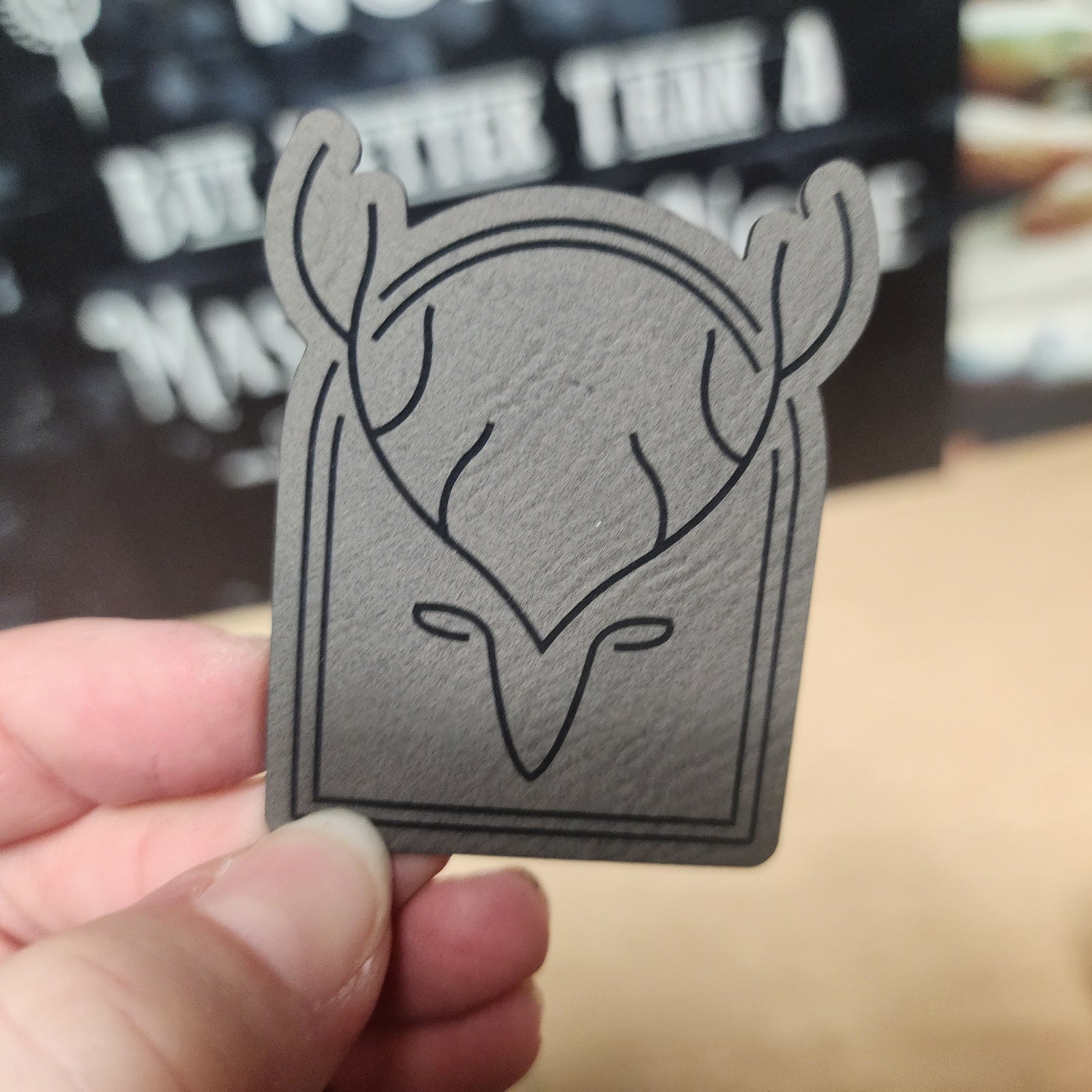 Stylish leatherette hat patch featuring a minimalist deer head design, perfect for outdoorsy fashion enthusiasts.