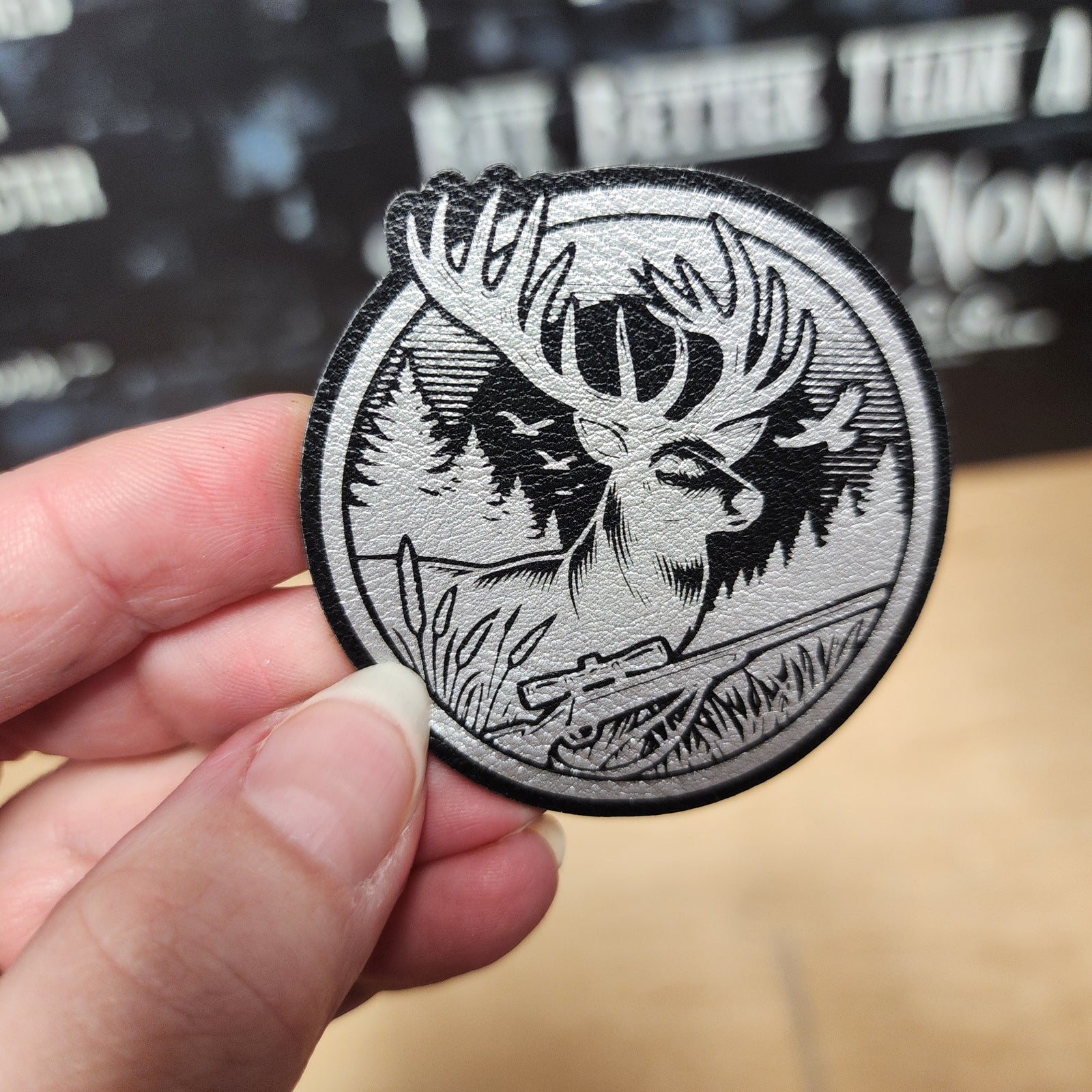 Wildlife leatherette hat patch featuring an intricately designed deer in a forest setting with a vintage aesthetic.