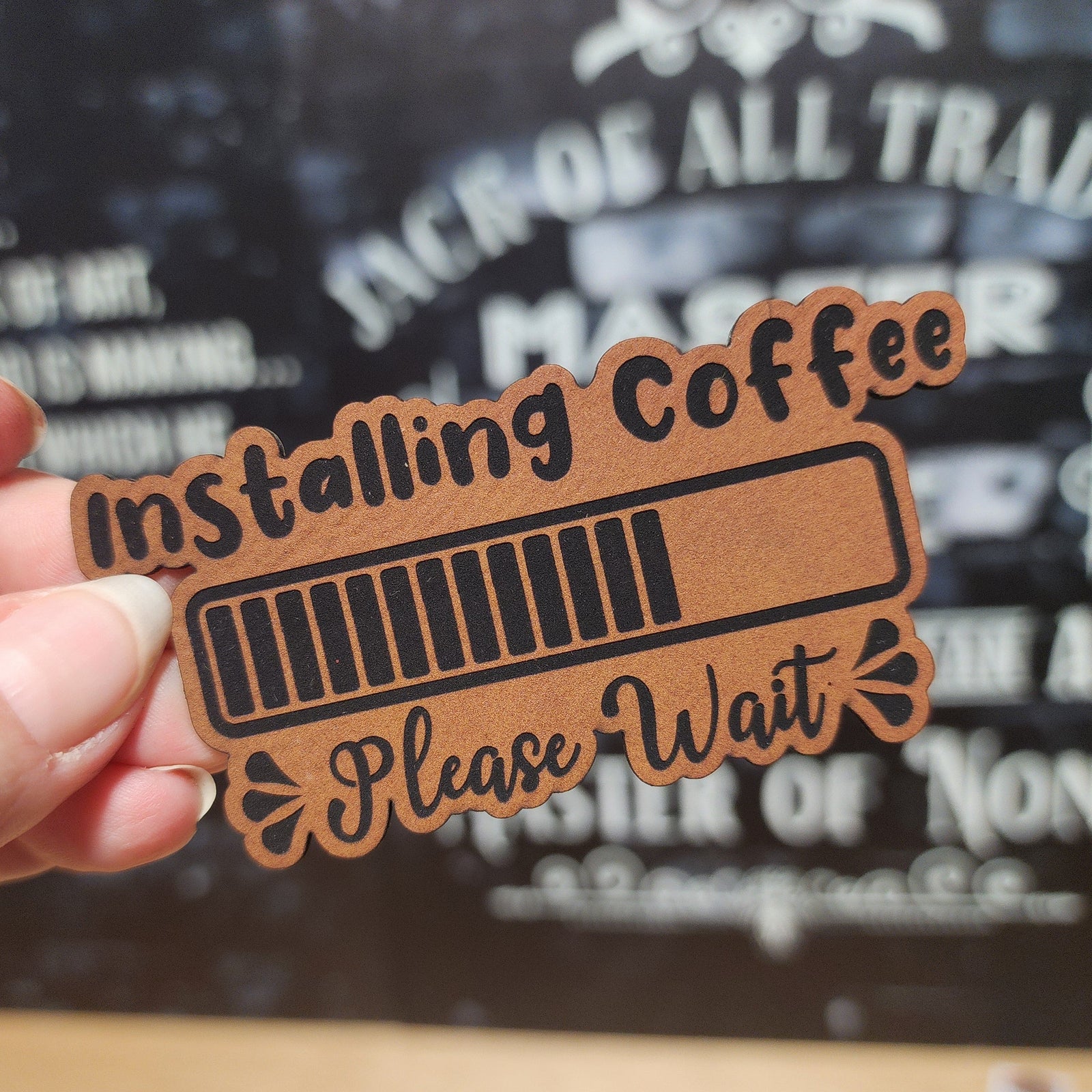 Installing coffee leatherette hat patch with playful design, perfect for coffee lovers and unique gifts.