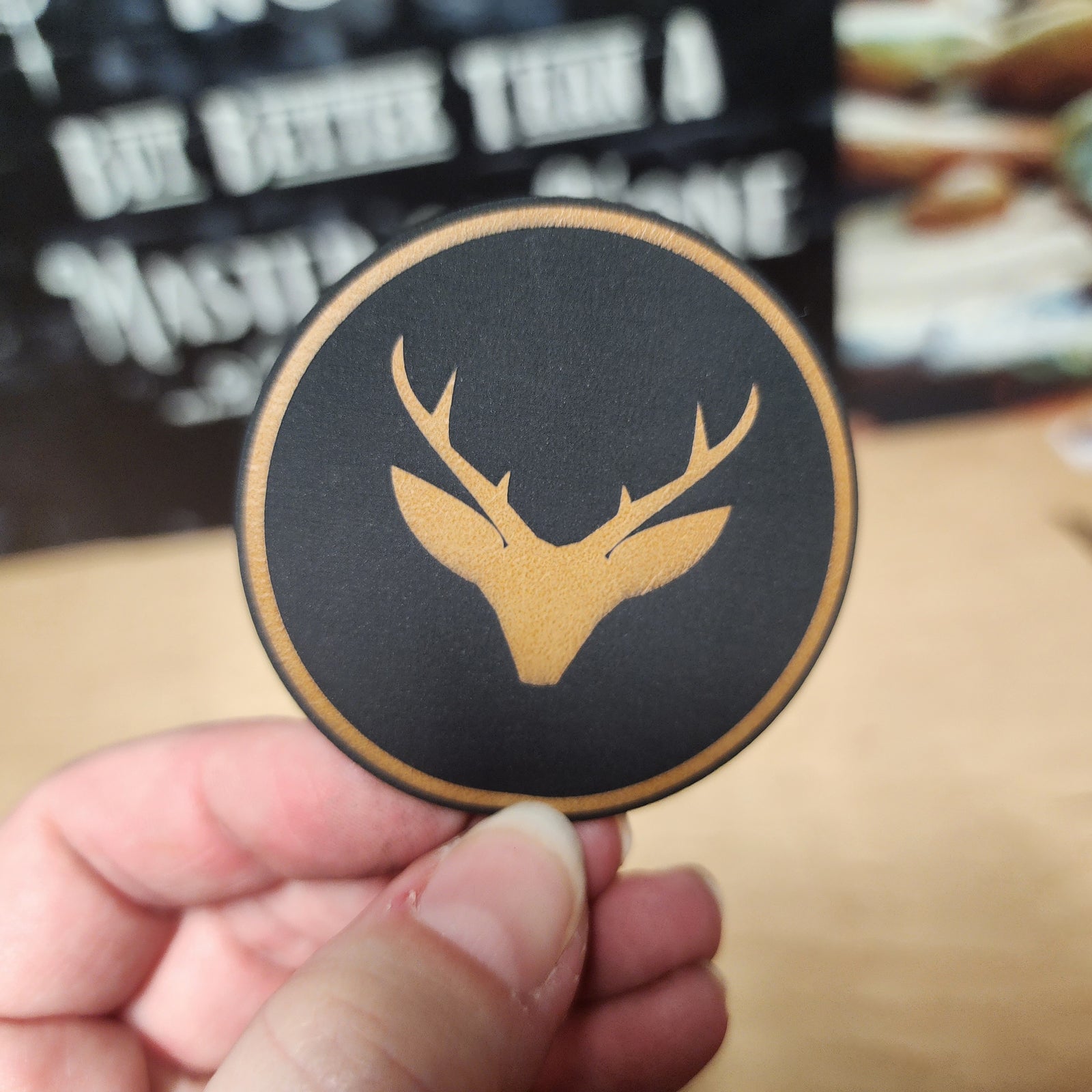 Rustic leatherette hat patch featuring a deer silhouette, perfect for outdoor enthusiasts and stylish cap accents.