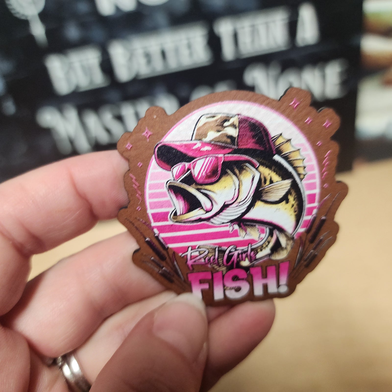 Reel Girls Fish leatherette hat patch featuring a stylish bass in sunglasses and cap, perfect for fishing enthusiasts.